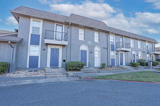 Row of our townhouse floorplans with blue doors and white trim at The Oasis apartments in Bossier City, LA