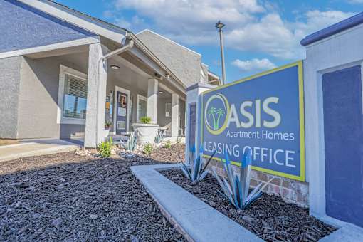 A sign for Oasis Leasing Office in front of the leasing office at The Oasis apartments in Bossier City, LA.