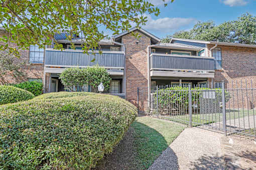 Apartment balconies and patios next to the pool gate with pool views at The Pearl apartments in Shreveport, LA