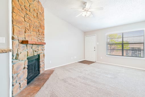 Carpeted Living Room at Terrace at Bookstone and Terrace Apartments in Irving, Texas
