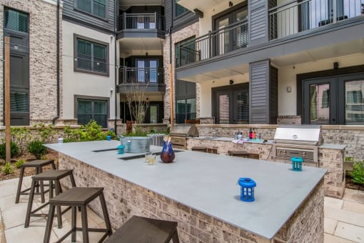 Barbecue Area in Courtyard at The Alastair at Aria Village Apartment Homes in Sandy Springs, Georgia, GA