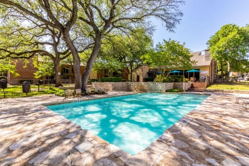 the pool covered by tree shades at Westdale Pointe in Austin, TX