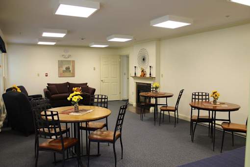 A dining room with a table set for six.