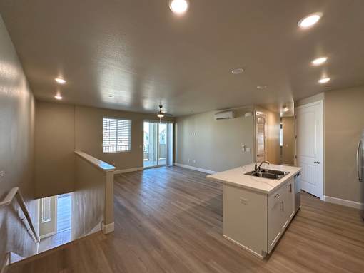 A kitchen area with a sink and cabinets.