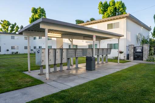 A parking garage with a white building in the background.