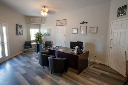 A reception area with a desk and chairs.