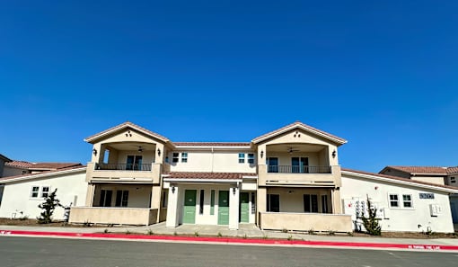 A row of houses with a blue sky above them.