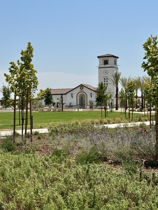 a building with a clock tower in a park