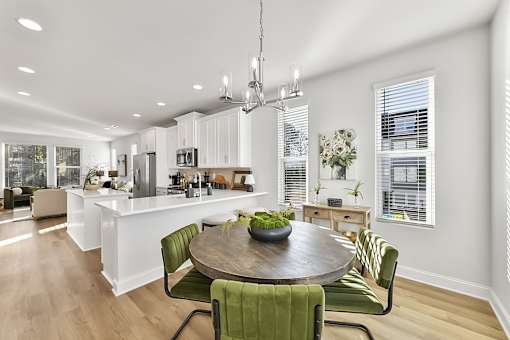 A modern kitchen with a dining table and chairs.