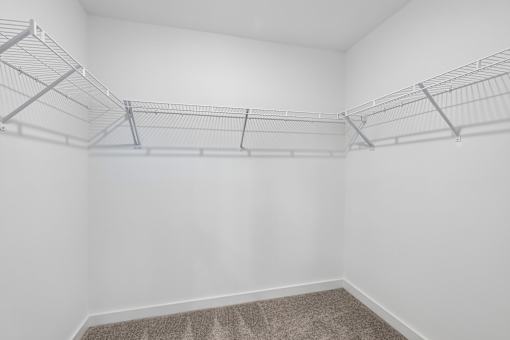 Empty room with white walls and a carpeted floor.