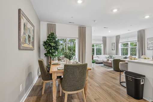 A dining room with a table and chairs.