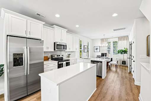 A modern kitchen with stainless steel appliances and white cabinetry.