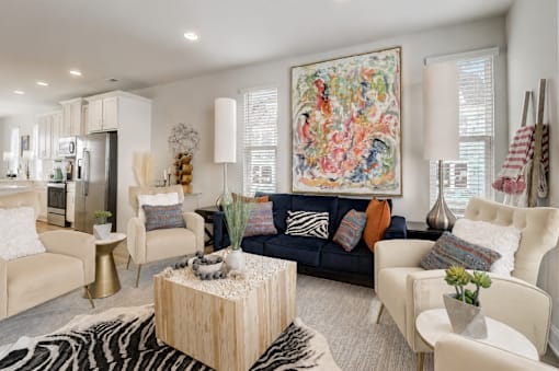 A living room with a large tapestry on the wall and a zebra print rug on the floor.