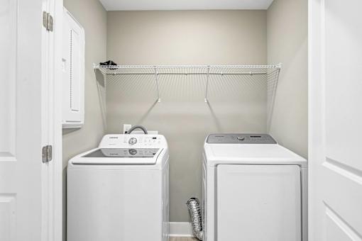 A small laundry room with a washer and dryer.