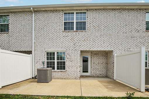 A brick house with a white garage door.