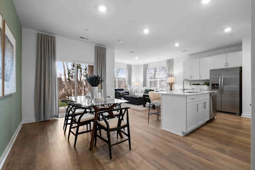 A modern kitchen with a dining table and chairs.