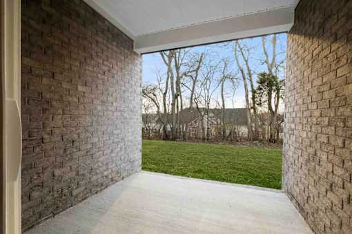 A view of a green field through a window.