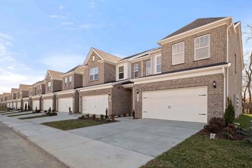 A row of houses with garages in front.