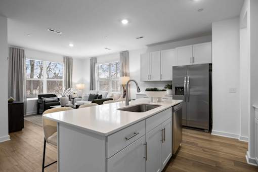 A modern kitchen with a large island and stainless steel appliances.