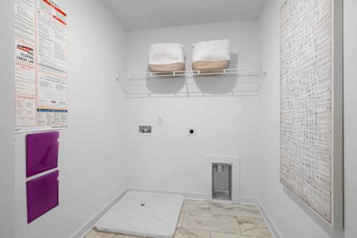 A bathroom with a toilet, a sink, and a towel rack.