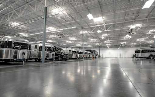 A large indoor space with several airstreams parked inside.