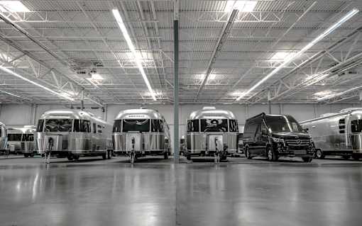 A photo of airstreams and a large sprinter vehicle.