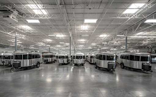 A large indoor space with several airstreams parked inside.
