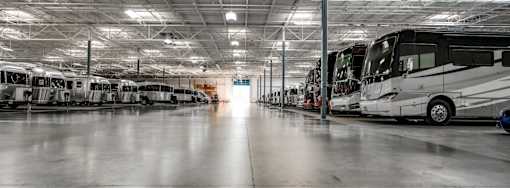 A large indoor space with a row of airstreams and diesel pushers.