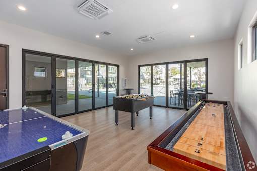 A room with a pool table and air conditioning unit.