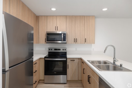 a kitchen with stainless steel appliances and wooden cabinets