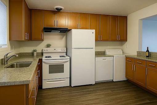 A kitchen with wooden cabinets and white appliances.
