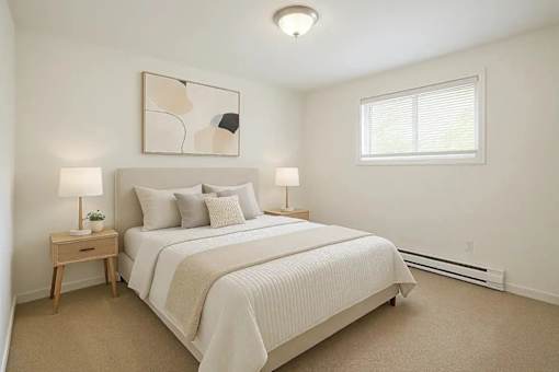 A bedroom with a bed, nightstands, and a painting on the wall.