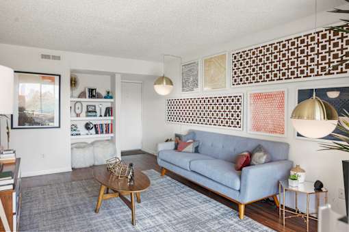 Modern living room with decorative wall art at Skyline at Barton Creek Apartments, Texas