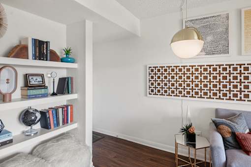 Living room with built in shelving and decorative panel at Skyline at Barton Creek Apartments, Austin, TX 78758