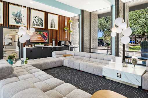 Clubhouse lounge with tufted seating and pendant lighting at Skyline at Barton Creek Apartments, Austin, TX