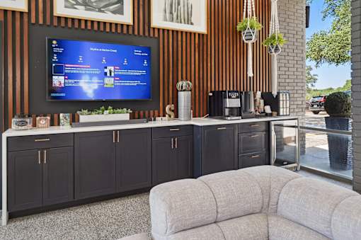 Outdoor entertainment area with coffee station and tv at Skyline at Barton Creek Apartments, Austin, 78758