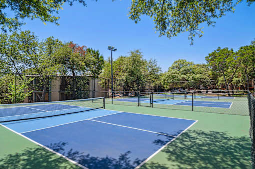 Tennis courts with professional surfacing at Skyline at Barton Creek Apartments, Austin