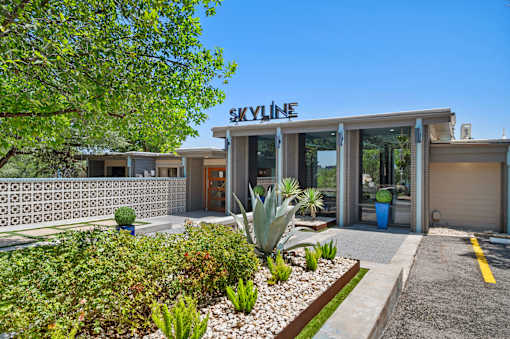 Property entrance with decorative breeze block wall at Skyline at Barton Creek Apartments, Texas