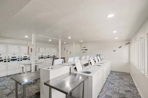 Community laundry facility with folding tables at Skyline at Barton Creek Apartments, Texas, 78758