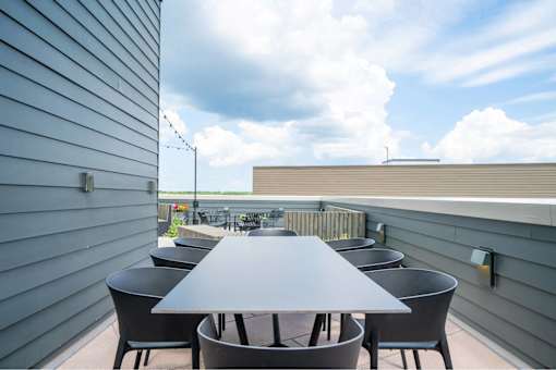 A table with chairs is set up on a patio.