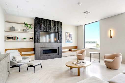 A modern living room with a fireplace and a view of the outdoors.