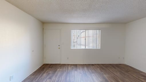 the spacious living room with wood flooring and a window at La Terraza, Phoenix, 85018