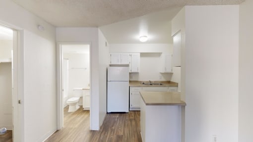 an empty kitchen with a white refrigerator and sink at La Terraza, Phoenix, 85018