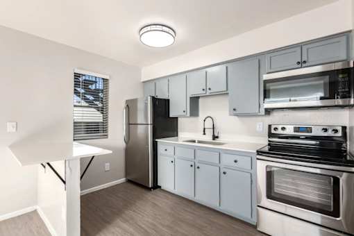 a kitchen with stainless steel appliances and white cabinets