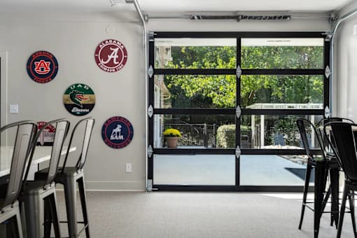 A room with a white wall and a glass door leading to a patio.