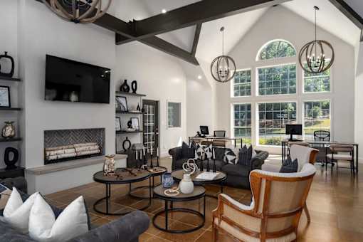 A modern living room with a fireplace and a large window.