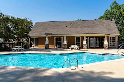 A house with a pool in front.