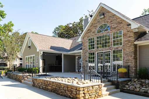 A house with a stone wall and a stone pillar.
