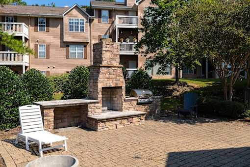 A patio with a fireplace and a chair.