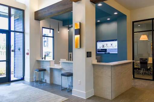 A modern office space with a bar area and a view of the outside.